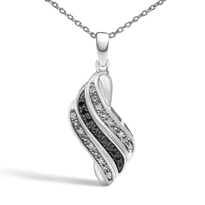 Close-up front angle of a white metal necklace pendant featuring alternating curved rows set with round white gemstones in pave setting and round black gemstones in prong setting, shown on a white background.
