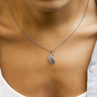 White metal necklace with a pendant featuring curved design lines set with white pave gemstones and black prong-set gemstones, shown worn on a model's neck in a close-up shot from the front.