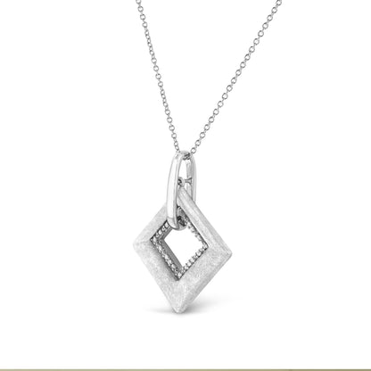 White metal necklace with a geometric pendant featuring a diamond-shaped outer frame and a pave-set inner frame of white gemstones, shown in a front-facing close-up angle.