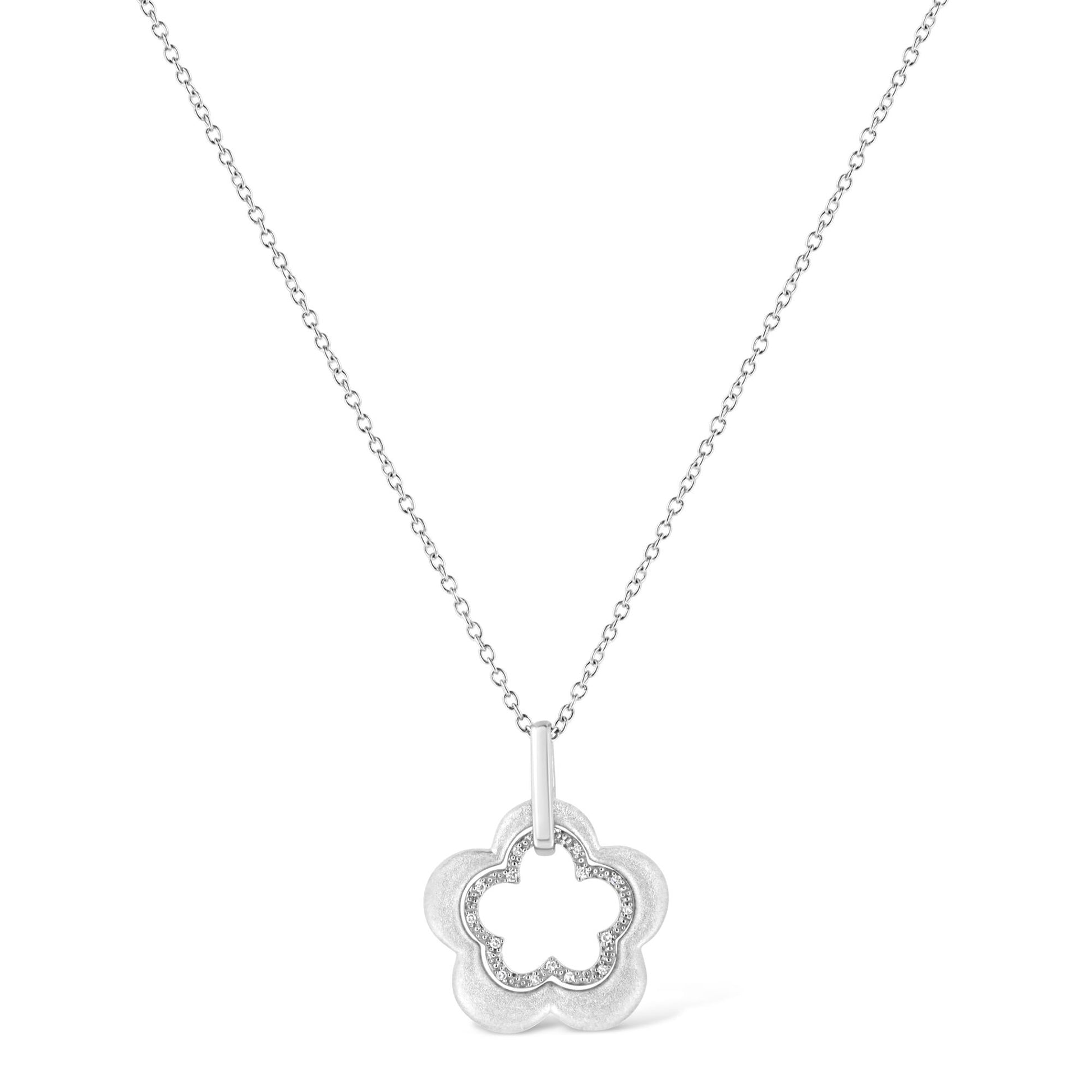 Front-facing shot of a white metal necklace with a flower-shaped pendant featuring an inner outline of round white gemstones in pave setting.