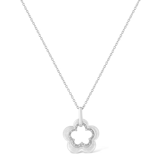 Front-facing shot of a white metal necklace with a flower-shaped pendant featuring an inner outline of round white gemstones in pave setting.