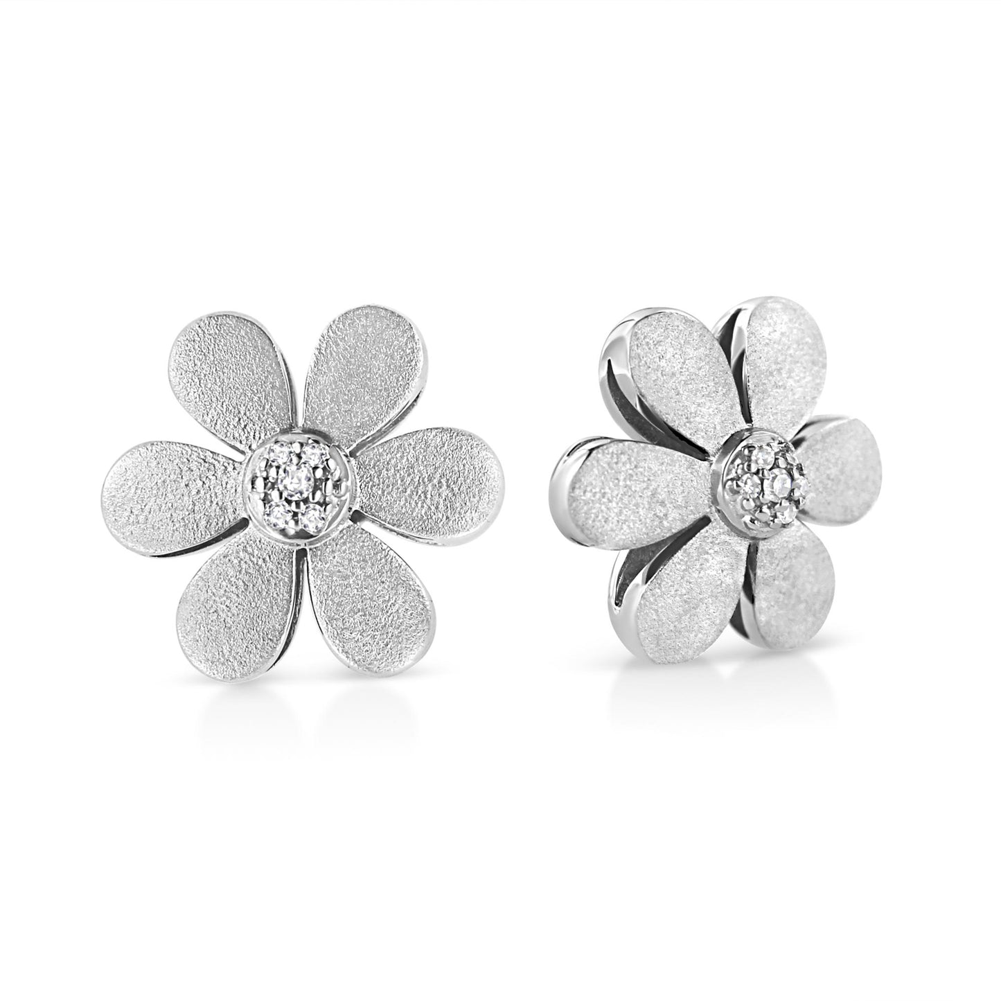 Close-up front and side view of white metal flower-shaped earrings with six textured petals and round pave-set white gemstones in the center.