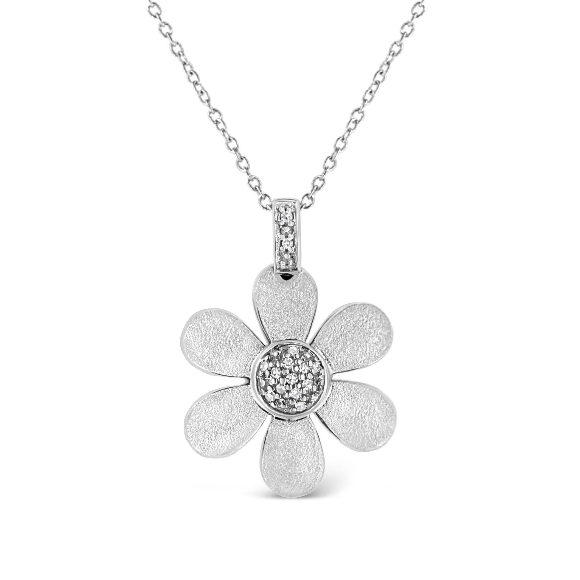 Front view of a white metal necklace with a flower-shaped pendant featuring textured petals and a center adorned with small white gemstones in a pave setting.