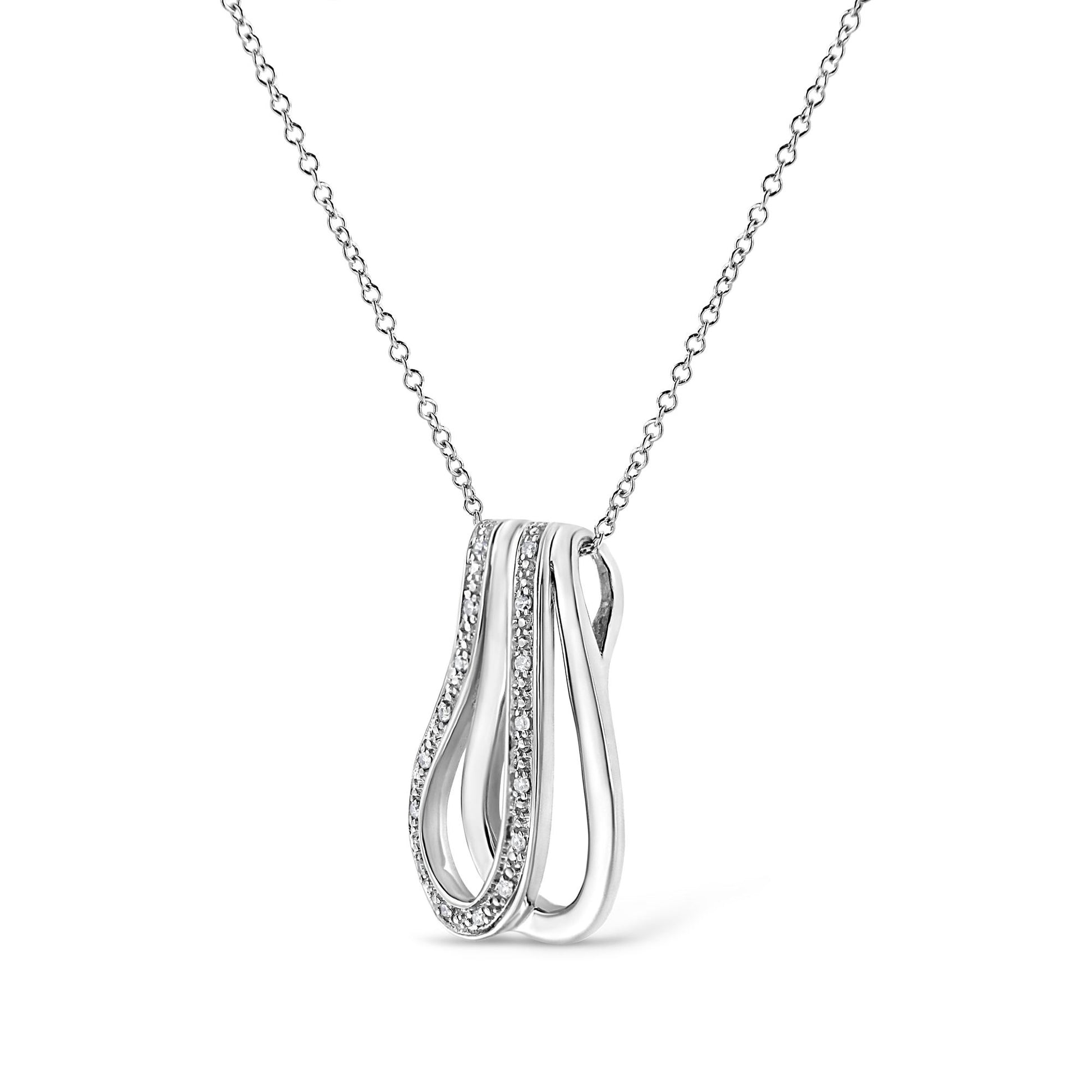 Close-up front angle of a white metal necklace with a pendant featuring flowing curves, one side adorned with pave-set round white gemstones.