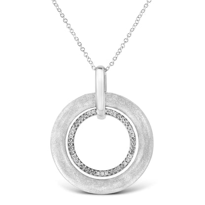 Front view of a white metal necklace featuring a round pendant with an outer textured circle and an inner circle studded with round white gemstones in prong settings.