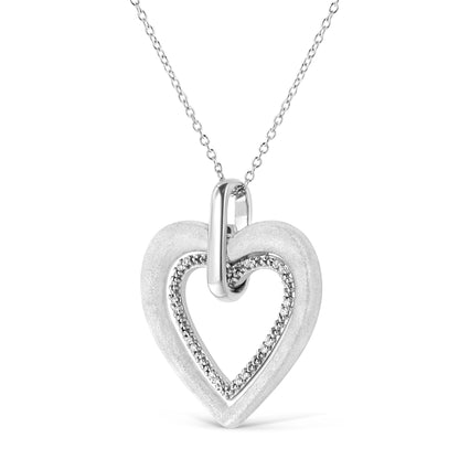Close-up front view of a white metal heart-shaped necklace pendant with an inner heart outline adorned with round white gemstones in prong settings.