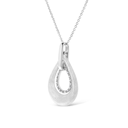 Front angled view of a white metal necklace with an open teardrop-shaped pendant featuring a textured outer loop and an inner loop adorned with round white gemstones in prong settings.