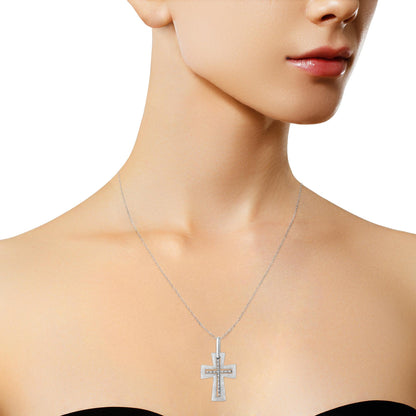 Close-up front view of a white metal necklace on a model featuring a cross-shaped pendant with two rows of round white gemstones in prong settings.