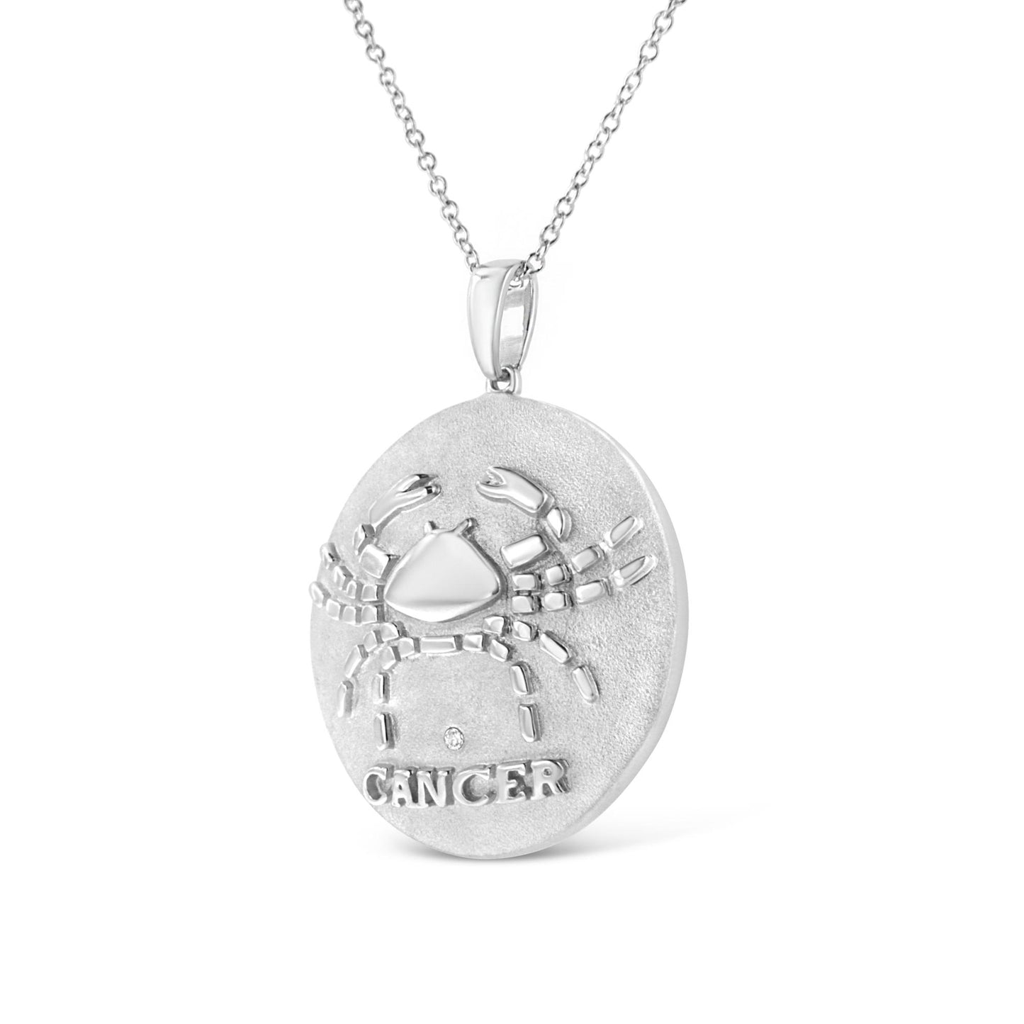 White metal round pendant necklace with crab design, bezel-set small brownish round gemstone below the crab, front angle.