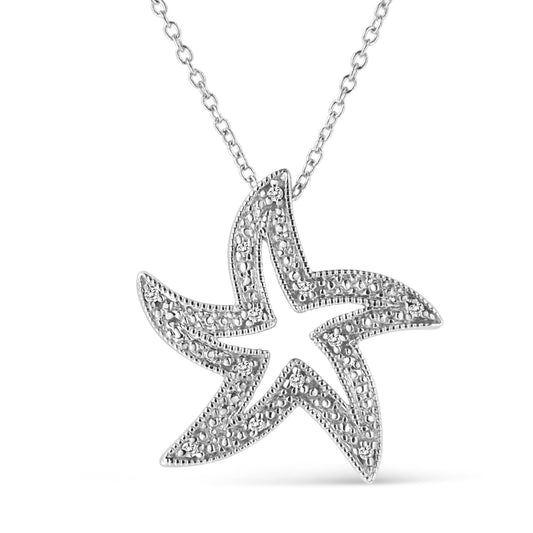 Front-facing view of a white metal star-shaped necklace pendant with small round white gemstones set in a prong setting, displayed against a white background.