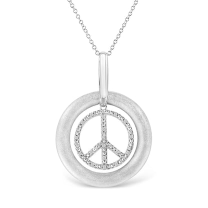 Front-facing shot of a white metal necklace with a pendant featuring a smooth circular outer ring and an inner peace symbol adorned with round white gemstones in prong settings.