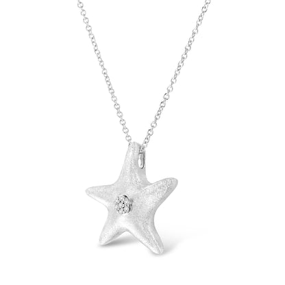 White metal star-shaped pendant necklace with round white gemstones in prong setting, shown from a front angle.
