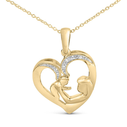Close-up front angle of a yellow metal heart-shaped necklace pendant featuring an abstract design of two figures facing each other, accented with a curved row of small white gemstones in a pave setting.