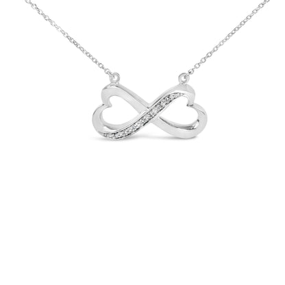 Close-up front view of a white metal infinity-shaped necklace pendant with a row of white gemstones in pave setting, shown on a white background.