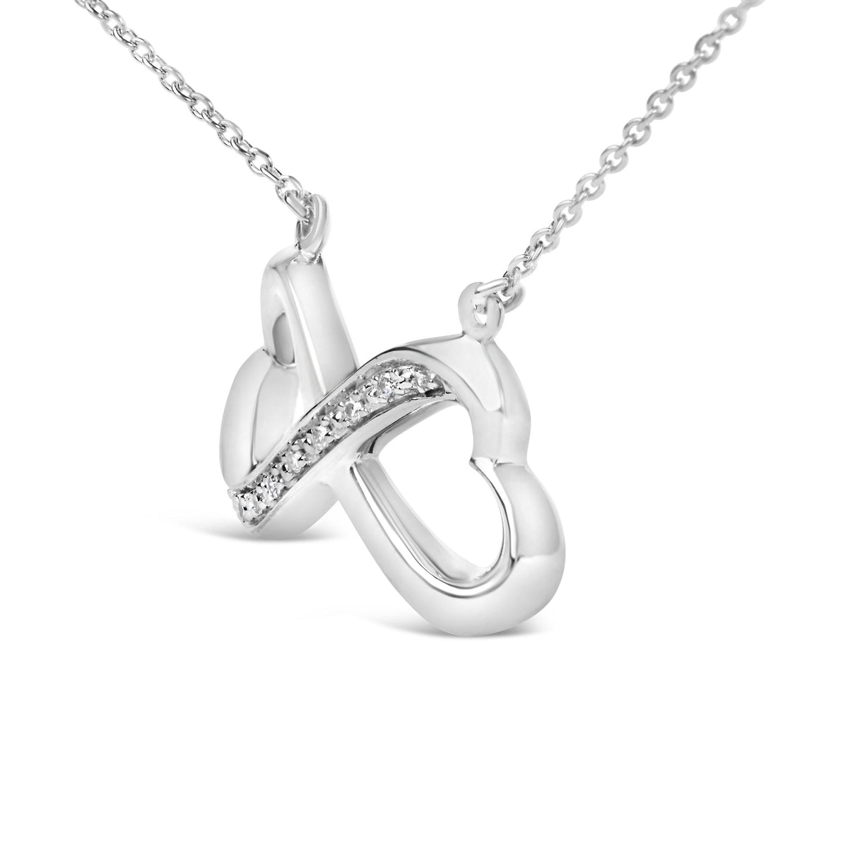 Close-up front angle of white metal necklace pendant with an intertwined loop design featuring a row of white gemstones in a pave setting along one loop.