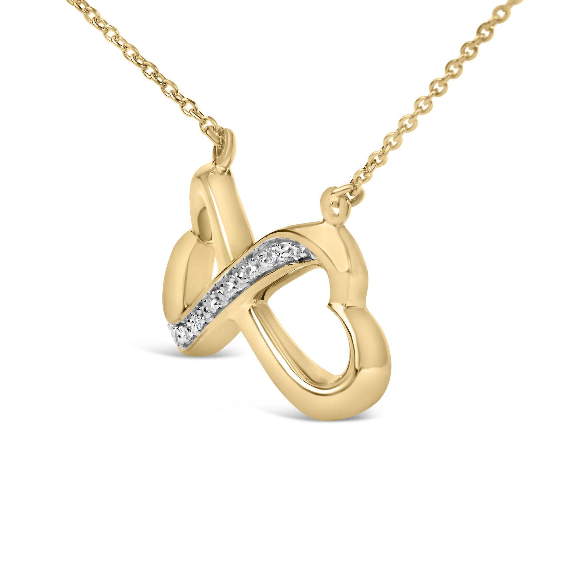 Close-up front angle of a yellow metal necklace pendant with an intertwined design featuring a pave setting of white round gemstones along one curve, shown on a white background.