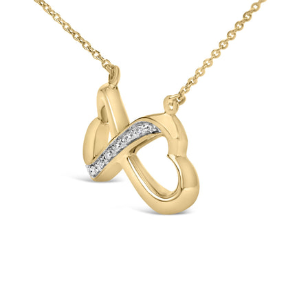 Close-up front angle of a yellow metal necklace pendant with an intertwined design featuring a pave setting of white round gemstones along one curve, shown on a white background.