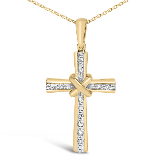Close-up front view of a yellow metal cross necklace pendant with a knot at the center and white gemstones set in a vertical and horizontal line, shown on a white background.