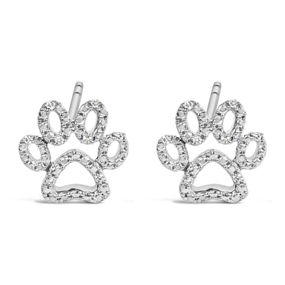 Close-up front view of a pair of white metal stud earrings shaped like paw prints, each outlined with multiple small round white gemstones in prong settings.