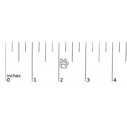 Close-up front view of a small yellow metal earring shaped like a paw print, outlined with white gemstones, shown on a measurement scale.