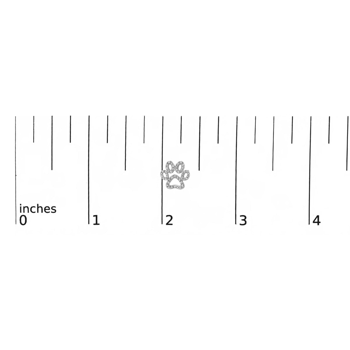 Close-up front view of a single white metal earring shaped like a paw print, adorned with multiple round white gemstones in prong settings, shown on a ruler scale.