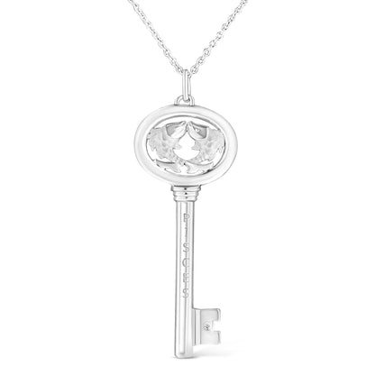 White metal necklace pendant in the shape of a key with two fish detailing inside the oval top, a round brownish gemstone bezel set near the key teeth, front-facing angle.