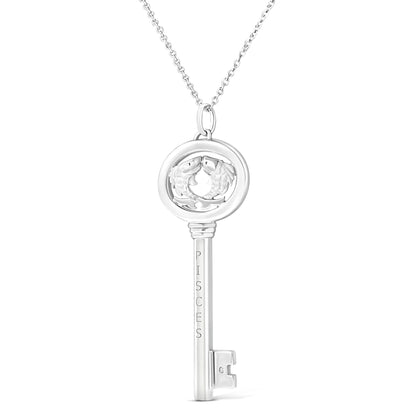 Front-facing image of a white metal key-shaped necklace pendant featuring two fish inside a circular top and a small brownish round gemstone near the bottom.