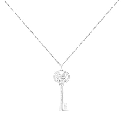 Front view of a white metal key-shaped necklace pendant with a round bezel-set brownish gemstone on the key bit, shown on a white background.