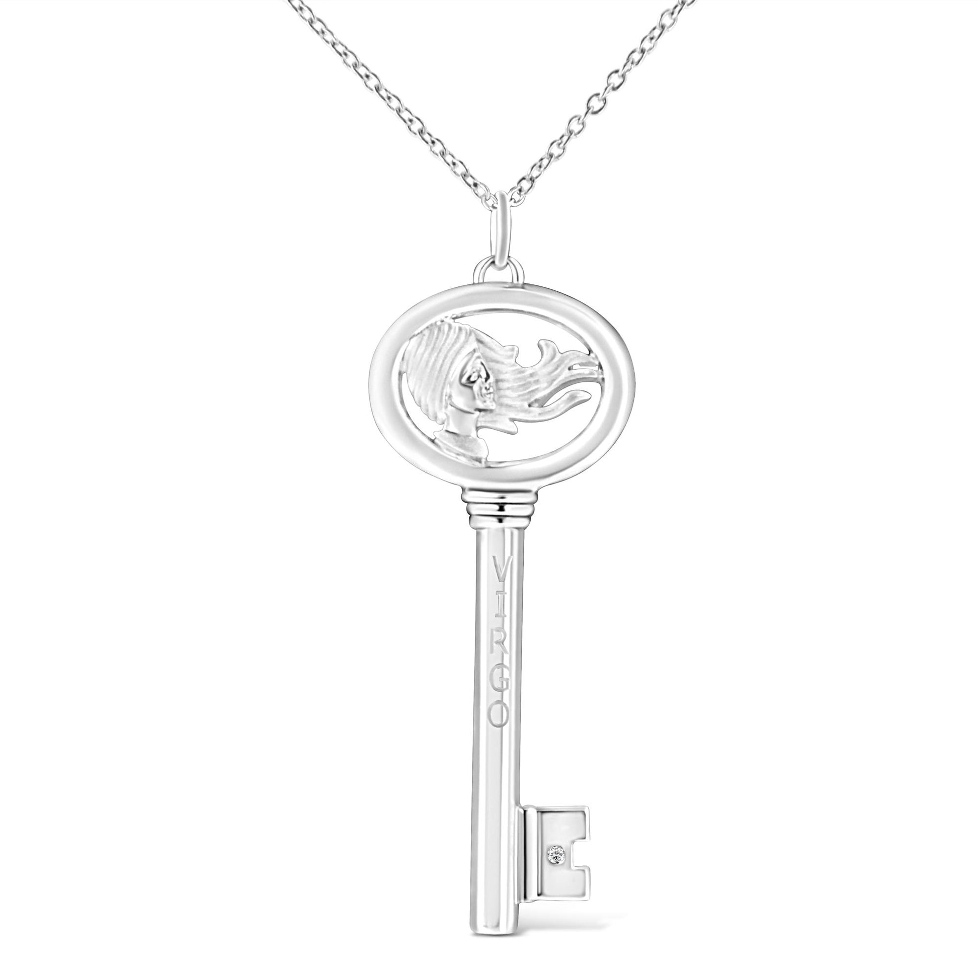 Front view of white metal key-shaped necklace pendant with an open oval top featuring a woman's profile with flowing hair and a small round brownish gemstone set near the key bit.