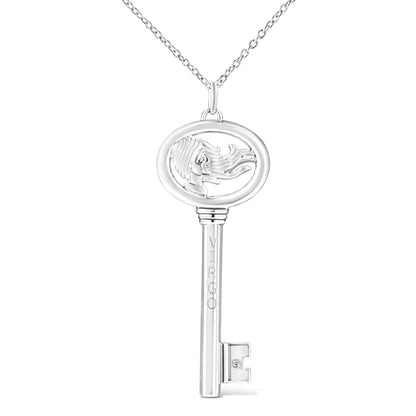Front view of white metal key-shaped necklace pendant with an open oval top featuring a woman's profile with flowing hair and a small round brownish gemstone set near the key bit.