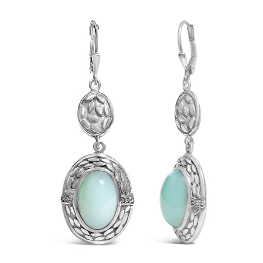 Front and side view of white metal dangle earrings featuring oval gray gemstones in bezel settings surrounded by decorative textured metal, accented with small round white gemstones in prong settings.