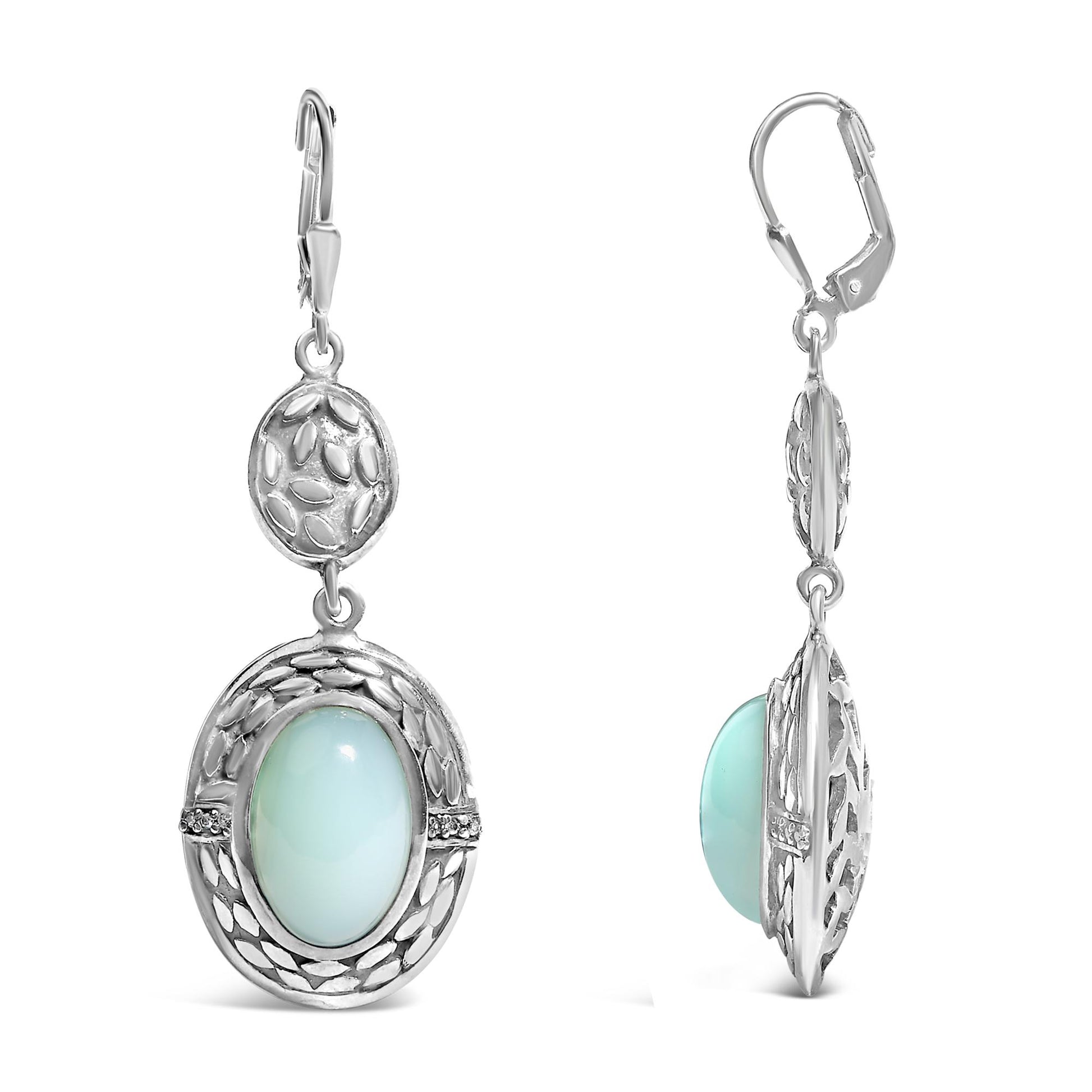 Pair of white metal dangle earrings with openwork oval shapes featuring a central oval gray gemstone in bezel setting and small round white gemstones in prong settings, shown from front and side angles.