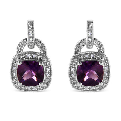 Front view of white metal earrings with cushion-shaped purple gemstones surrounded by round white gemstones in pave setting.