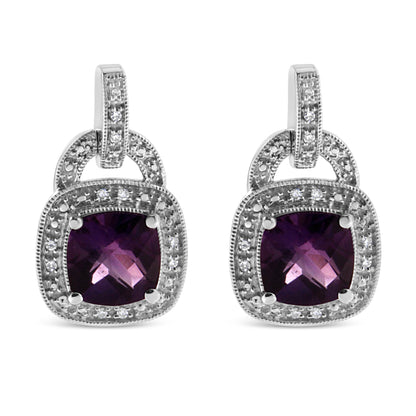 Front-facing close-up of a pair of white metal earrings featuring cushion-shaped purple gemstones in prong settings, surrounded by round white gemstones in pavé settings.