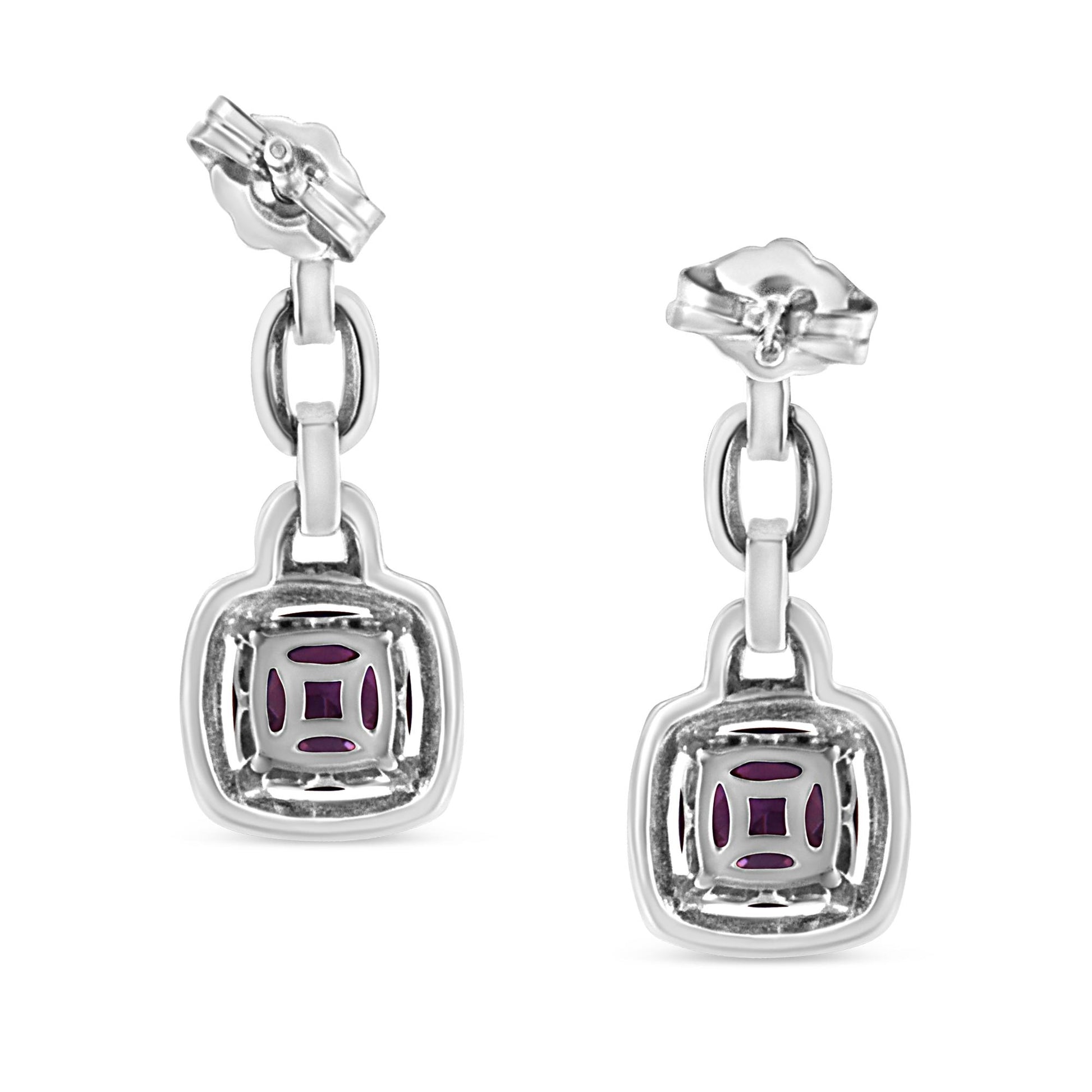 Front-angle view of white metal dangle earrings featuring a square-shaped setting with purple cushion gemstones and multiple round white gemstones in prong settings.