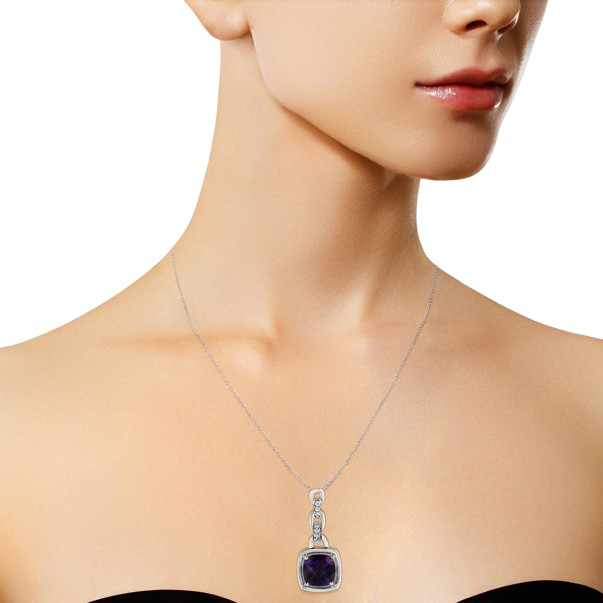 White metal necklace on a model with a pendant featuring a purple cushion-shaped gemstone and small round white gemstones, shot from a front angle.