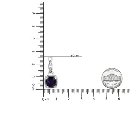 White metal necklace pendant with a purple cushion-shaped gemstone and six round white gemstones in prong settings, shown flat on a ruler and scale for size reference, shot from above.
