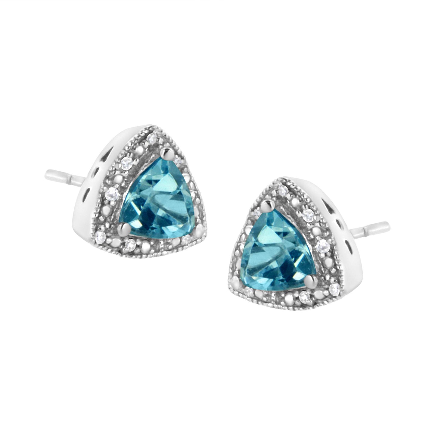 Close-up front angle of white metal stud earrings with triangular blue gemstones surrounded by small round white gemstones in prong settings.