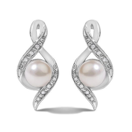 Close-up front view of a pair of white metal earrings with an abstract loop design accented with pave white gemstones and a large round pearl at the base, shown on a white background.