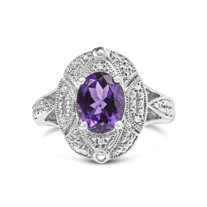 Front-facing shot of a white metal ring featuring an oval purple gemstone in the center with surrounding round white gemstones in prong settings.