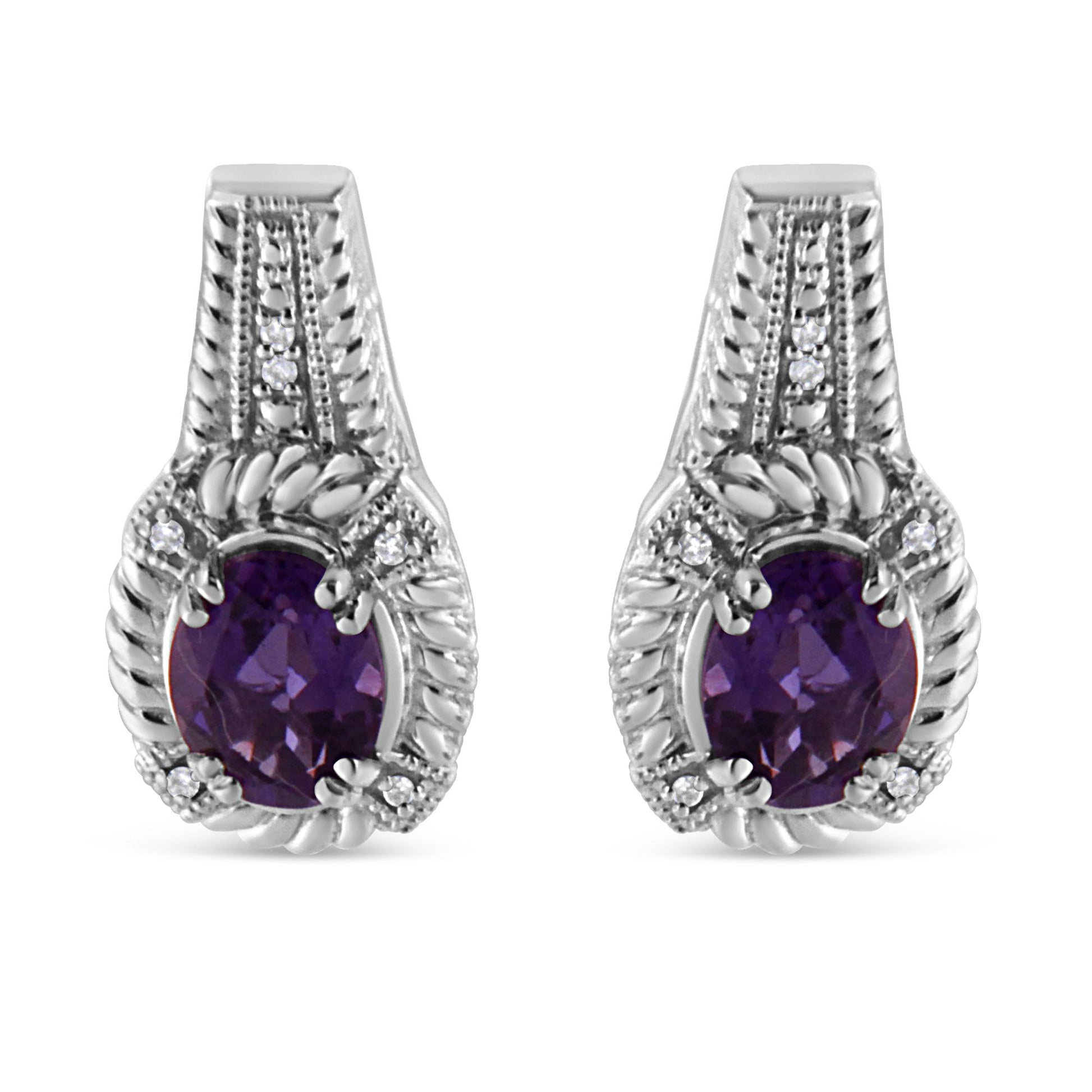 Front-facing view of white metal earrings featuring oval purple gemstones surrounded by pave set round white gemstones.
