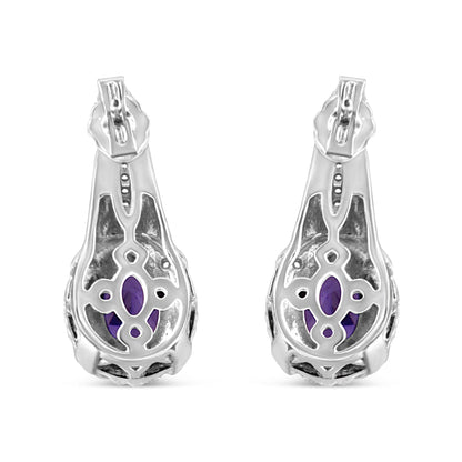 Pair of white metal earrings shown from the back, featuring oval purple gemstones visible through decorative openwork, with small round white gemstones in pave setting.