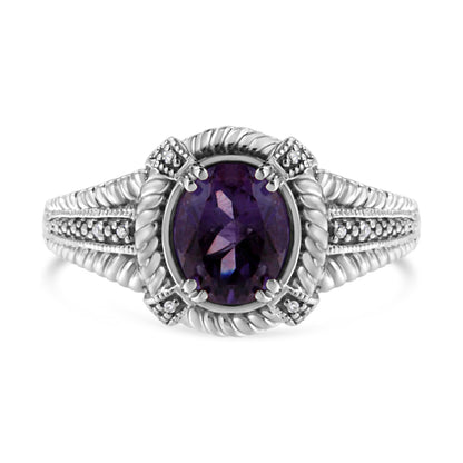 Front view of a white ring with an oval purple gemstone center, surrounded by eight round white gemstones in a pave setting on the band and around the center stone.