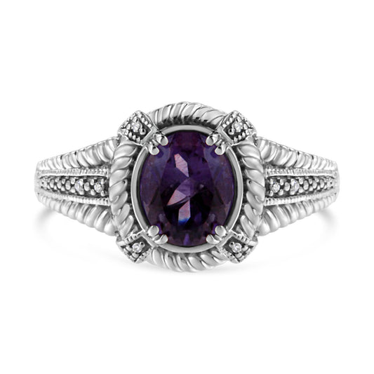 Front view of a white ring with an oval purple gemstone center, surrounded by eight round white gemstones in a pave setting on the band and around the center stone.