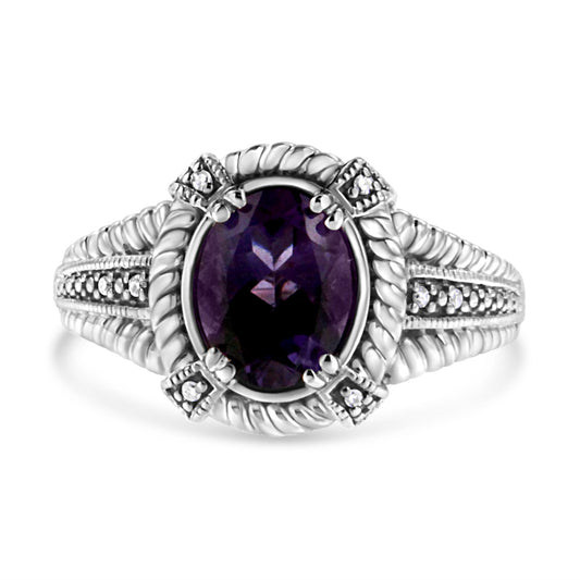Front view of white ring featuring an oval purple gemstone center set with prongs, surrounded by round white gemstones in a pave setting along the band and around the center stone.