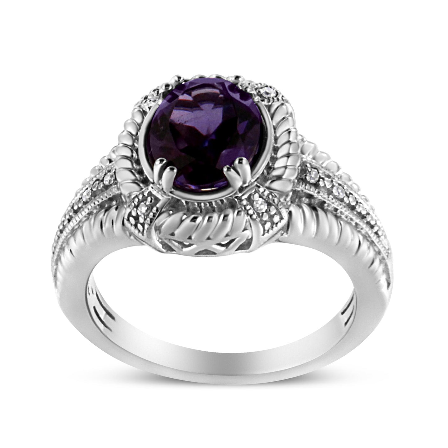 White metal ring with an oval purple gemstone in prong setting on top, surrounded by round white gemstones in pave setting, shown in a front angle.