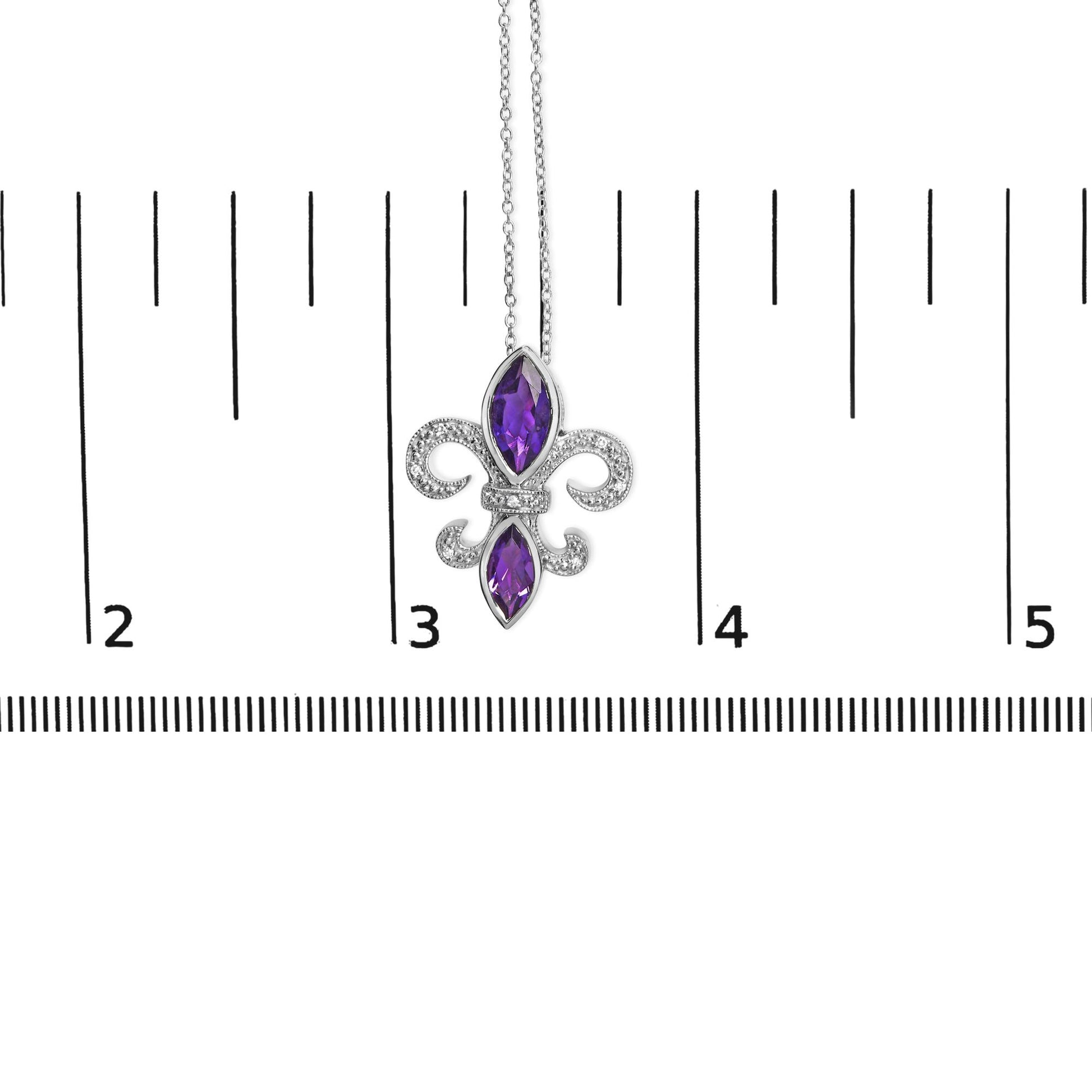 Close-up front view of a white metal necklace pendant with two purple marquise-shaped gemstones in bezel settings and seven round white gemstones in prong settings, displayed on a ruler for size reference.