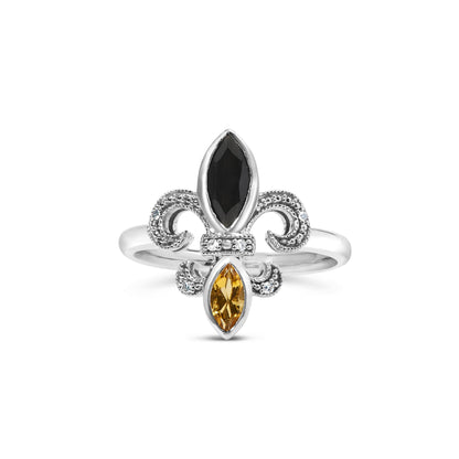 Front view of a white metal ring featuring a fleur-de-lis design with a black marquise-shaped gemstone at the top, an orange marquise-shaped gemstone at the bottom, and small white round gemstones set in pave style around the design.
