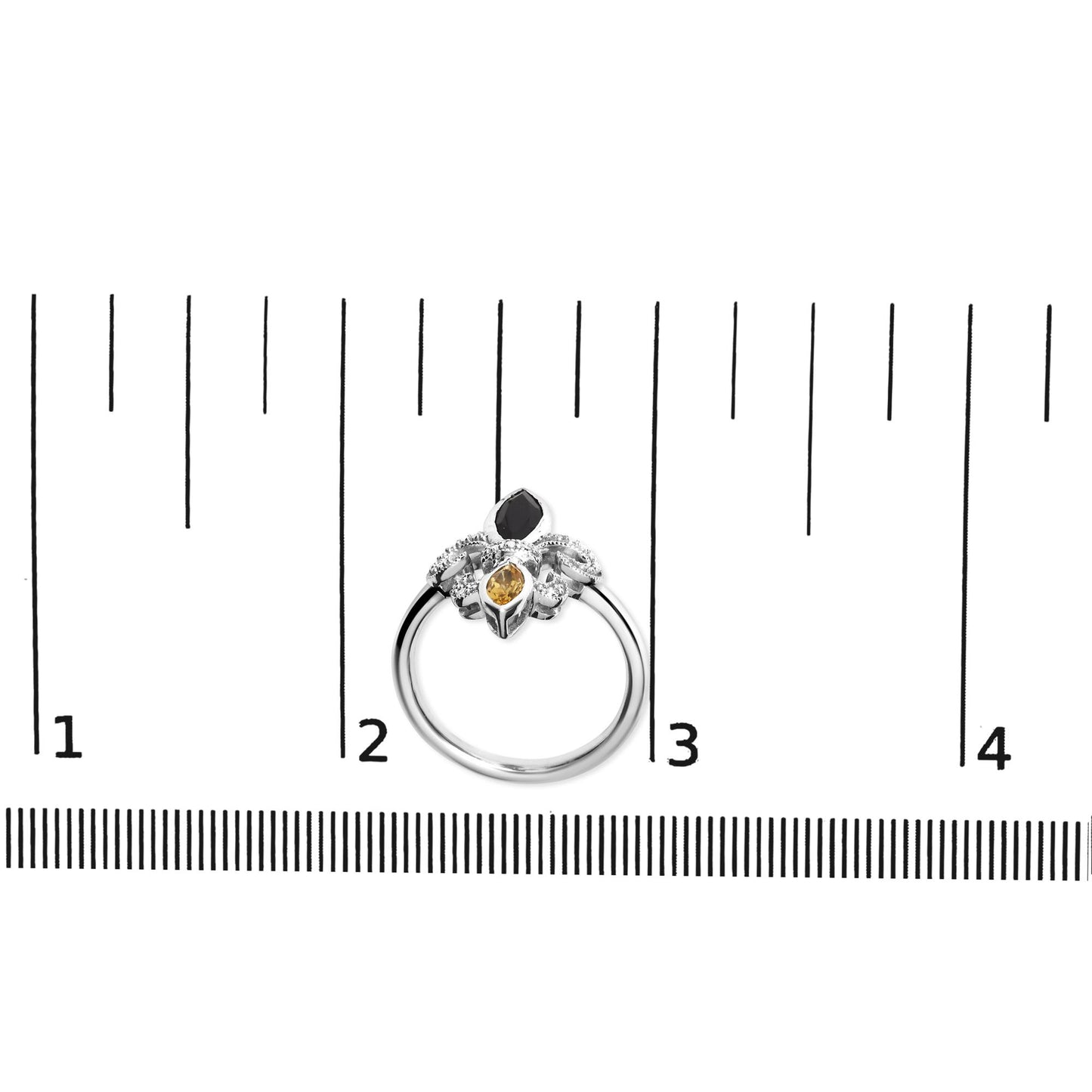 White ring with two marquise-shaped orange gemstones and white round gemstones in a pave setting, shown on a ruler for size reference, top-down angle.