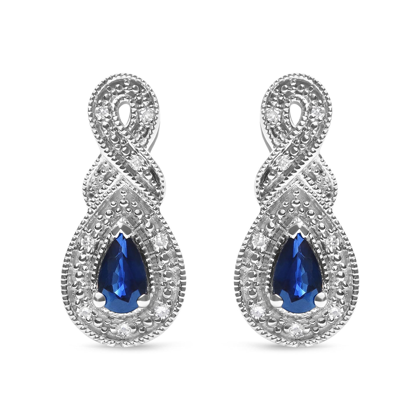 Front-facing close-up of white metal earrings featuring pear-shaped blue gemstones surrounded by round white gemstones in a prong setting, with an intertwined design above the gemstones.